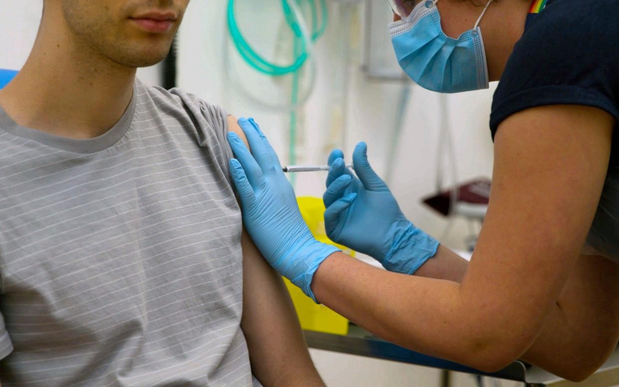 A volunteer at Oxford University is injected with either an experimental coronavirus vaccine or a comparison shot as part of the first human trials of a potential jab in the UK - Oxford University