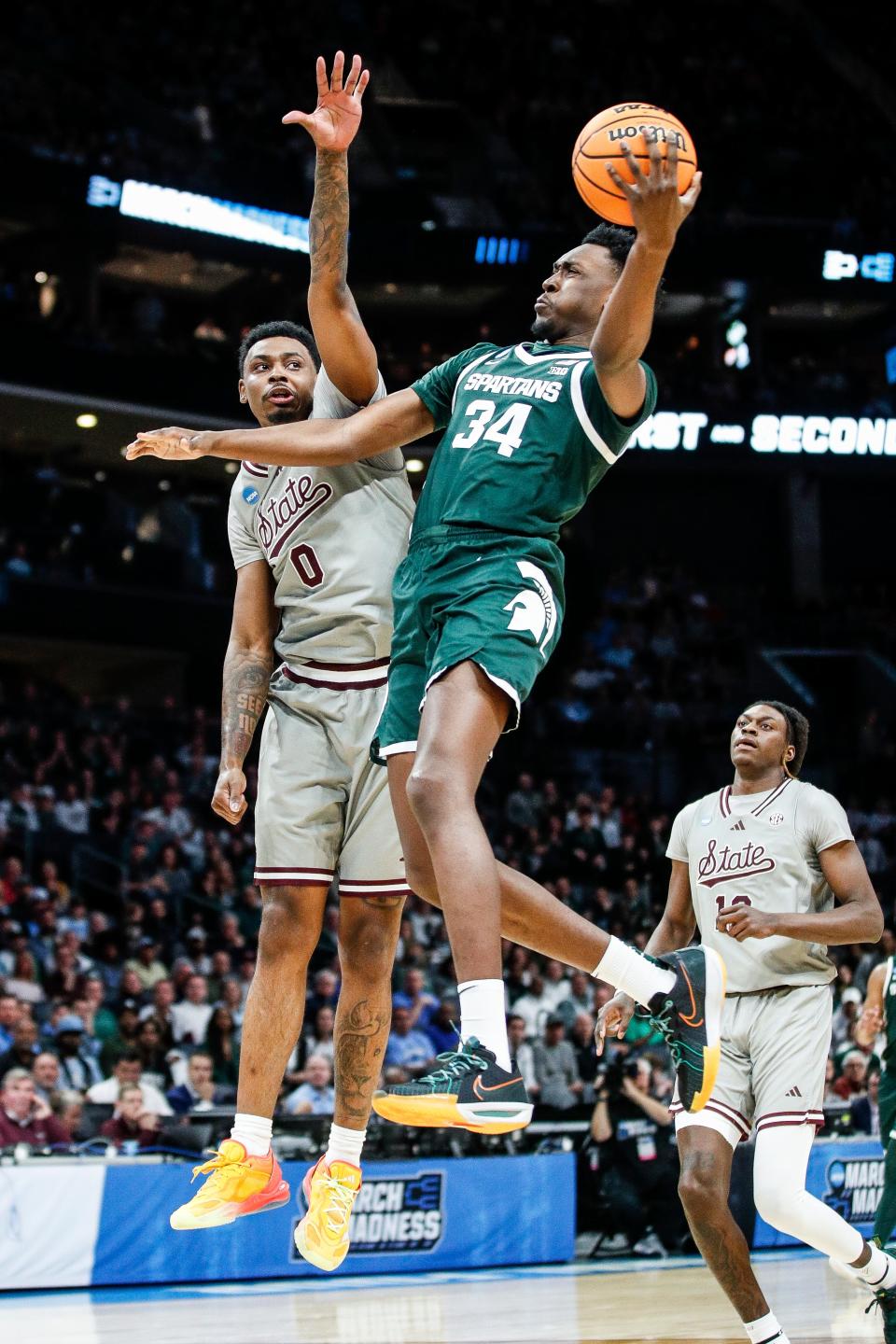 Michigan State forward Xavier Booker (34) goes to the basket against Mississippi State forward D.J. Jeffries (0) during the first half of NCAA tournament West Region first round at Spectrum Center in Charlotte, N.C. on Thursday, March 21, 2024.