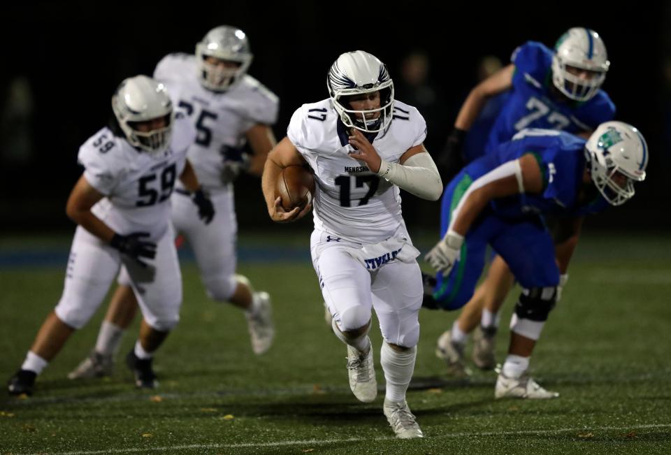 Menasha's Logan Liegl runs for a first down against Green Bay Notre Dame during their football game Sept. 29 in Green Bay.