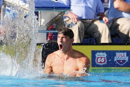 Aug 8, 2015; San Antonio, TX, USA; Michael Phelps celebrates winning the men's 100-meter butterfly final during the Phillips 66 National Championships at Northside Swim Center. Mandatory Credit: Soobum Im-USA TODAY Sports