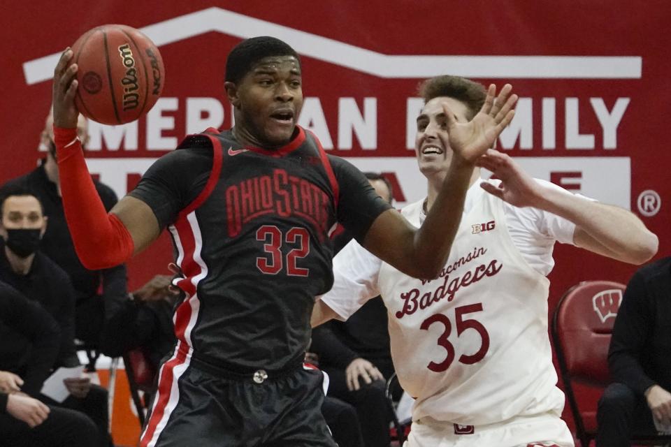 Ohio State's E.J. Liddell rebounds over Wisconsin's Nate Reuvers during the second half of an NCAA college basketball game Saturday, Jan. 23, 2021, in Madison, Wis. (AP Photo/Morry Gash)