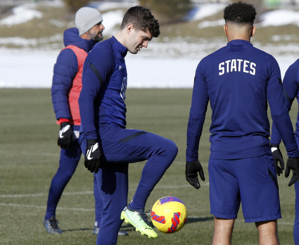 U.S. men's national team soccer Christian Pulisic, left, talks with midfielder Tyler Adams during practice in Columbus, Ohio, Wednesday, Jan. 26, 2022, ahead of Thursday's World Cup qualifying match against El Salvador. (AP Photo/Paul Vernon)