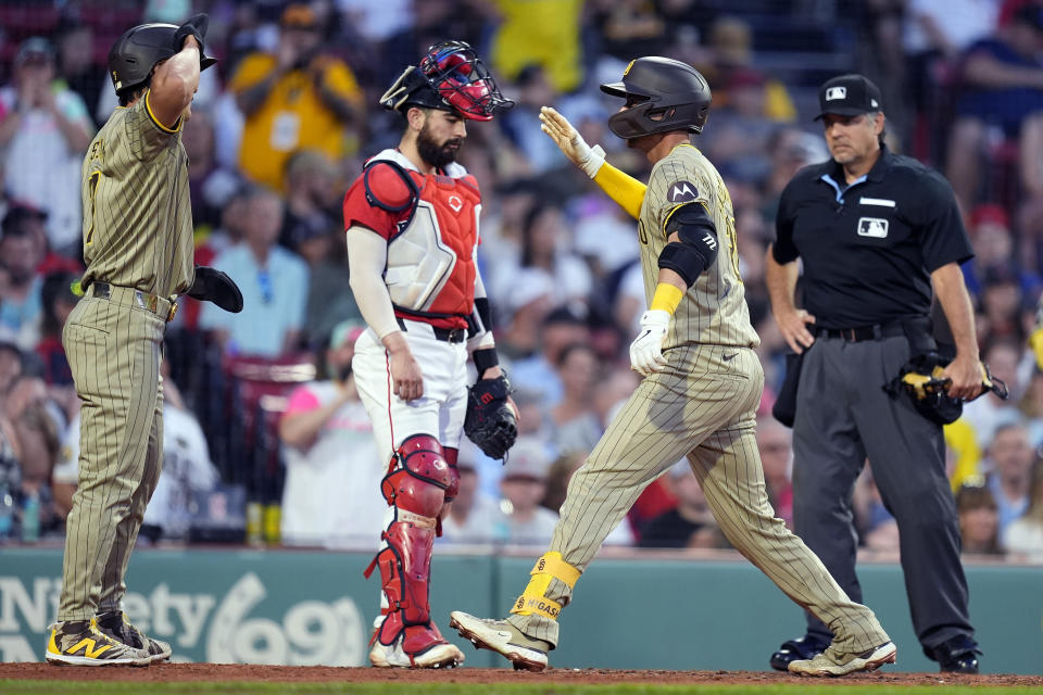 San Diego Padres' Kyle Higashioka right, celebrates his two-run home run that scored Ha-Seong Kim, left, in front of Boston Red Sox catcher Connor Wong during the fifth inning of a baseball game Friday, June 28. 2024, in Boston. (AP Photo/Michael Dwyer)