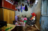 Ahmad Farea and his family sit for a meal at their house in Sanaa