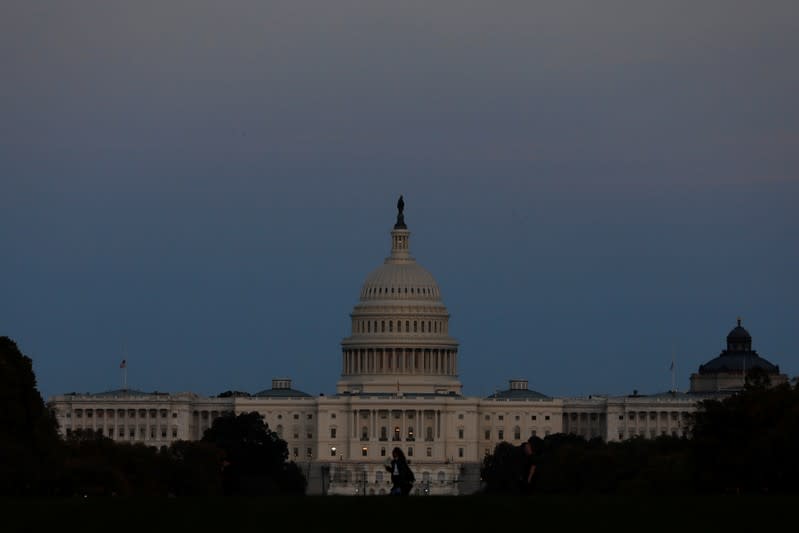 People walk past the U.S. Capitol Building in Washington