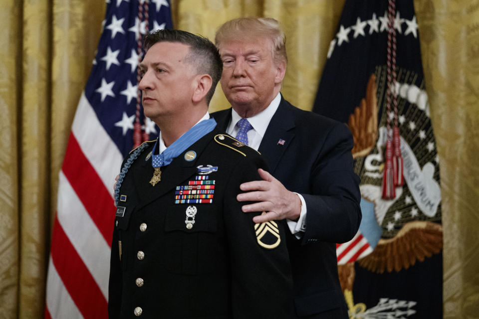 President Donald Trump awards the Medal of Honor to Army Staff Sgt. David Bellavia in the East Room of the White House in Washington, Tuesday, June 25, 2019, for conspicuous gallantry while serving in support of Operation Phantom Fury in Fallujah, Iraq. (AP Photo/Carolyn Kaster)