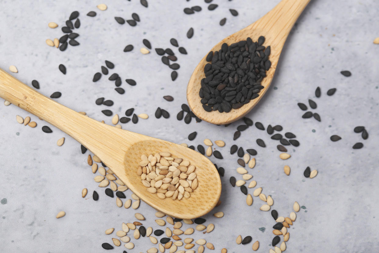 Sesame seeds on wooden spoons.