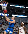 Boise State guard Jace Whiting (15) shoots a layup next to Texas A&M guard Tyrece Radford (23) during the first half of an NCAA college basketball game in Fort Worth, Texas, Saturday, Dec. 3, 2022. (AP Photo/Emil Lippe)