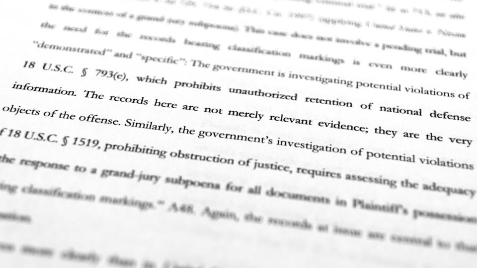 A page from the Justice Department's motion to the 11th Circuit U.S. Court of Appeals in Atlanta are photographed Friday, Sept. 16, 2022. The Justice Department asked the federal appeals court to lift a judge's order that temporarily barred it from reviewing a batch of classified documents seized during an FBI search of former President Donald Trump's Florida home last month. (AP Photo/Jon Elswick)