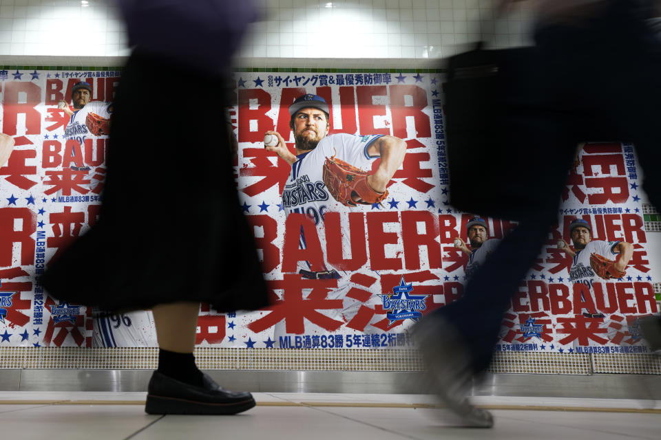 Posters of Trevor Bauer who's pitching for the Yokohama BayStars are placed at the pathway of a train station on Tuesday, May 2, 2023, in Yokohama near Tokyo. Bauer will pitch his first official game for the Yokohama DeNA BayStars on Wednesday and, to promote the start, a local department store is to unveil a seven-story poster of the former Cy Young winner on the building's facade. (AP Photo/Eugene Hoshiko)