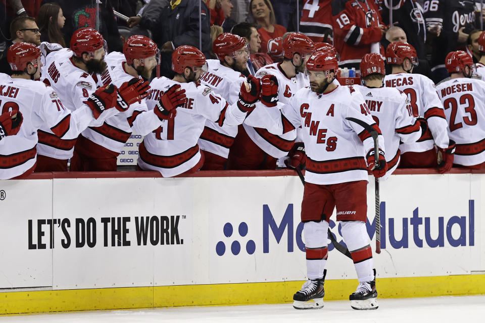 Carolina Hurricanes left wing Jordan Martinook celebrates with teammates after scoring a penalty shot against the New Jersey Devils during the second period of Game 3 of an NHL hockey Stanley Cup second-round playoff series Sunday, May 7, 2023, in Newark, N.J. (AP Photo/Adam Hunger)