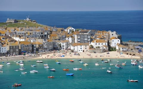 St Ives, Cornwall, UK: looking down at the harbor with small boats and the beach - Credit: Paul Melling / Alamy