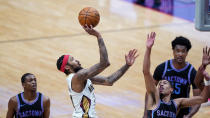 New Orleans Pelicans forward Brandon Ingram (14) shoots over Sacramento Kings guard Tyrese Haliburton, right, in the second half of an NBA basketball game in New Orleans, Monday, April 12, 2021. The Pelicans won 117-110. (AP Photo/Gerald Herbert)