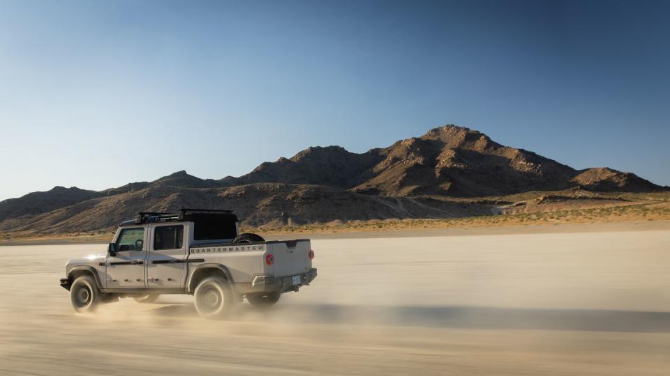 a truck driving on a desert road