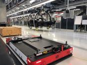 Automated vehicles carry parts for building Porsche Taycan electric cars at Porsche's Zuffenhausen manufacturing complex, in Stuttgart