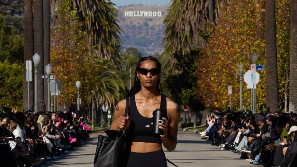 a model wearing black workout gear walks the outdoor runway in balenciaga's fall 2024 show