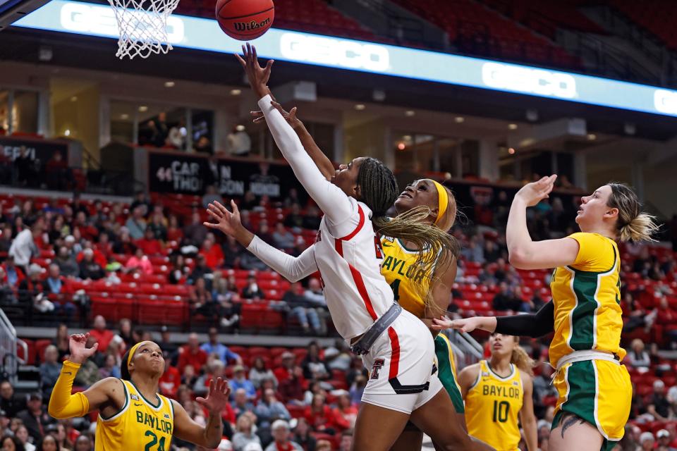 Texas Tech's Taylah Thomas (24) lays up the ball around Baylor's Queen Egbo (4) during the first half of an NCAA college basketball game on Wednesday, Jan. 26, 2022, in Lubbock, Texas. (AP Photo/Brad Tollefson) ORG XMIT: TXBT107