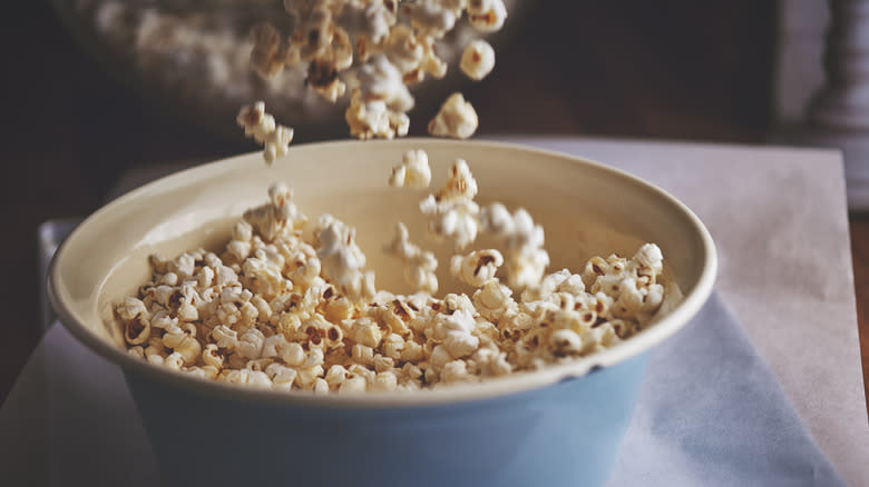Pouring popcorn into a bowl