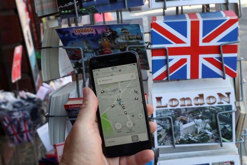 FILE PHOTO: A photo illustration shows the Uber app and London themed postcards in London