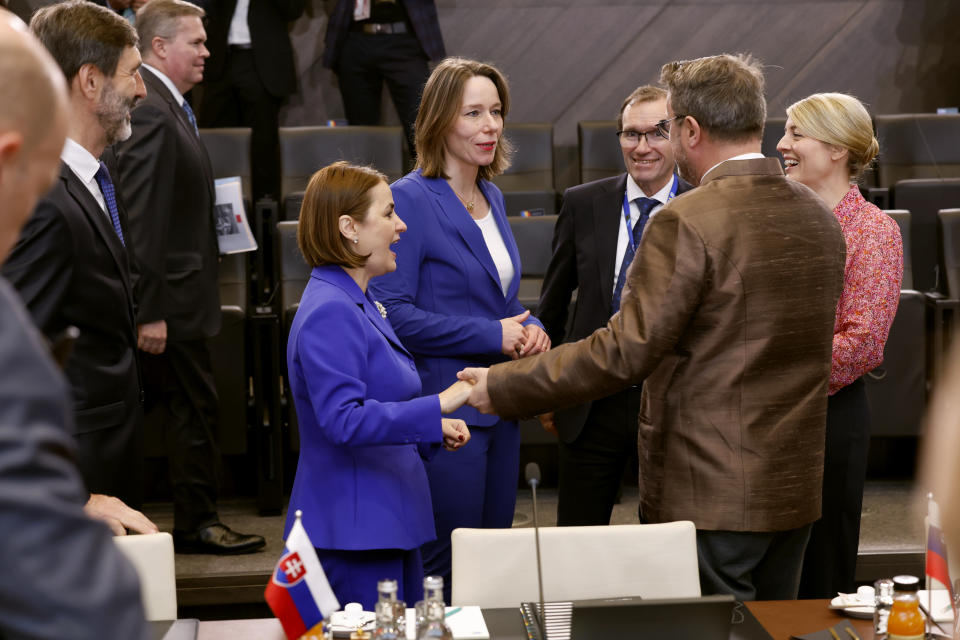 Romania's Foreign Minister Luminita-Teodora Odobescu, fourth left, and Netherland's Foreign Minister Hanke Bruins Slot, center, speaks with Luxembourg's Foreign Minister Xavier Bettel, second right, and Canada's Foreign Minister Melanie Joly, right, during a meeting of the NATO-Ukraine Council at NATO headquarters in Brussels, Thursday, April 4, 2024. NATO celebrates on Thursday 75 years of collective defense across Europe and North America as Russia's war on Ukraine enters its third year. (AP Photo/Geert Vanden Wijngaert)