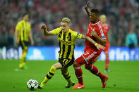 Marco Reus of Borussia Dortmund (L) in action with Jerome Boateng of Bayern Muenchen.