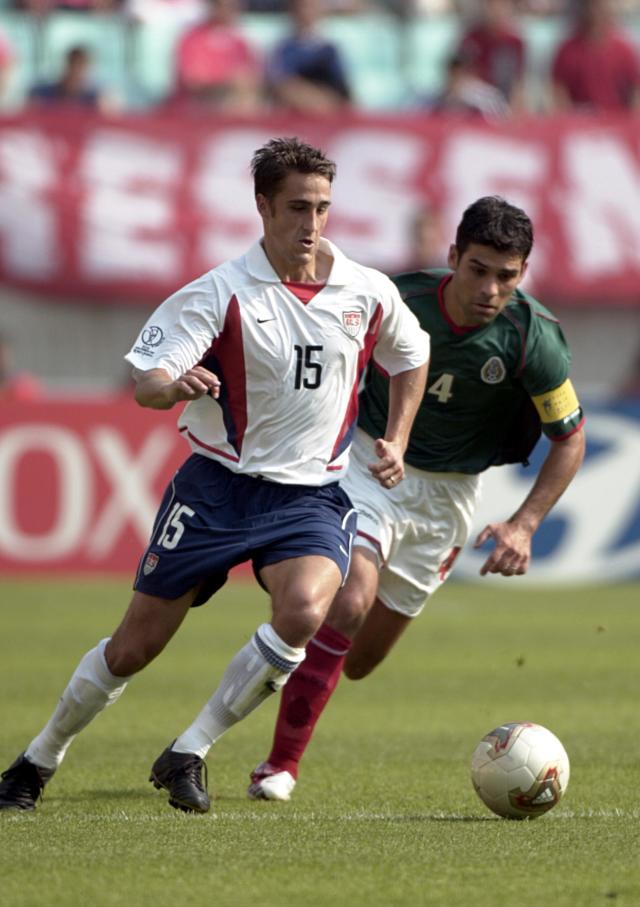 Wolff, shown here battling Mexican great Rafa Marquez, played for the the U.S. at the 2002 and 2006 World Cups. (Michael Stahlschmidt/Getty)