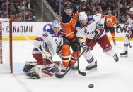 New York Rangers goalie Alexandar Georgiev (40) makes a save as Edmonton Oilers' Zach Hyman (18) and Jacob Trouba (8) battle in front of him during second-period NHL hockey game action in Edmonton, Alberta, Friday, Nov. 5, 2021. (Jason Franson/The Canadian Press via AP)