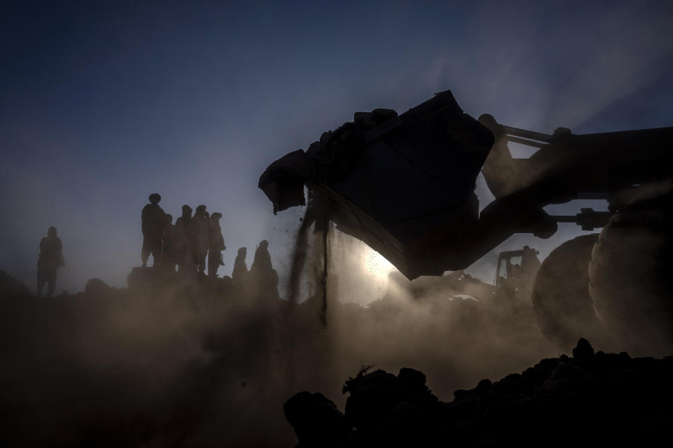 Afghan men search for victims after an earthquake in Zenda Jan district in Herat province, of western Afghanistan, Monday, Oct. 9, 2023. Saturday's deadly earthquake killed and injured thousands when it leveled an untold number of homes in Herat province. (AP Photo/Ebrahim Noroozi)