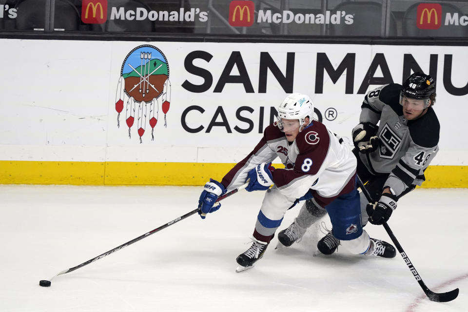 Colorado Avalanche defenseman Cale Makar (8) reaches for the puck next to Los Angeles Kings left wing Brendan Lemieux (48) during the first period of an NHL hockey game Saturday, May 8, 2021, in Los Angeles. (AP Photo/Marcio Jose Sanchez)