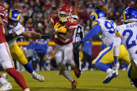 Kansas City Chiefs running back Isiah Pacheco (10) runs from Los Angeles Rams defensive tackle Michael Hoecht, right, during the second half of an NFL football game Sunday, Nov. 27, 2022, in Kansas City, Mo. (AP Photo/Ed Zurga)