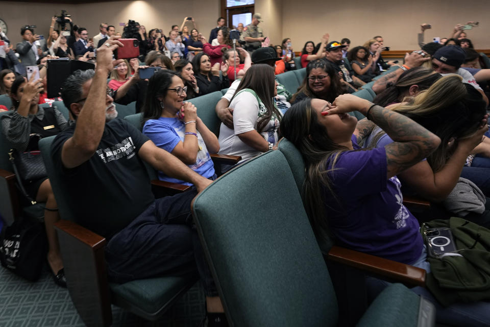 Family members of the victims of the Uvalde shootings react after a Texas House committee voted to take up a bill to limit the age for purchasing AR-15 style weapons in the full House in Austin, Texas, Monday, May 8, 2023. (AP Photo/Eric Gay)