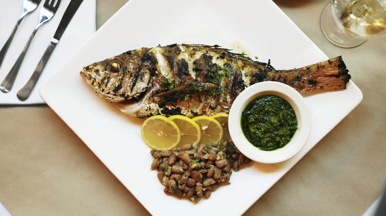 Whole cooked fish on plate