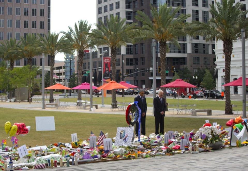 President Barack Obama and Vice President Joe Biden visit a memorial to the victims of the Pulse nightclub shooting, Thursday, June 16, 2016 in Orlando, Fla. (AP Photo/Pablo Martinez Monsivais)