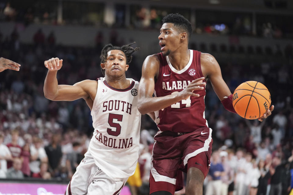 Alabama forward Brandon Miller (24) drives against South Carolina guard Meechie Johnson (5) during overtime in an NCAA college basketball game Wednesday, Feb. 22, 2022, in Columbia, S.C. Alabama won 78-76. (AP Photo/Sean Rayford)