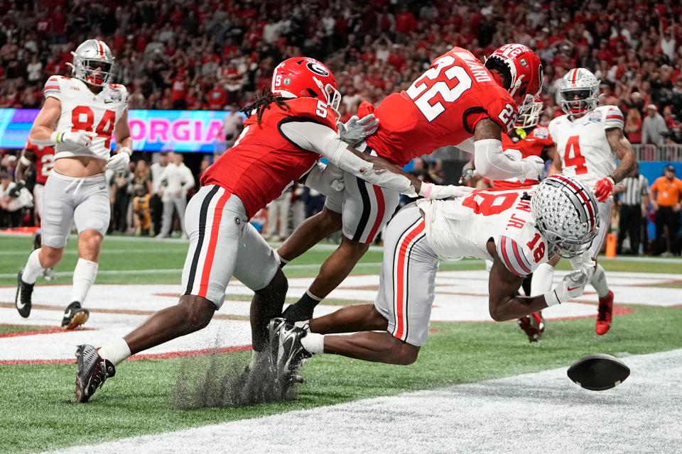 Ohio State receiver Marvin Harrison Jr. takes a hit from Georgia safety Javon Bullard in a College Football Playoff semifinal.