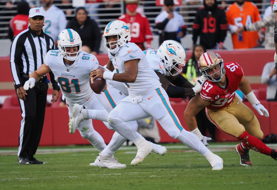 Dolphins quarterback Tua Tagovailoa escapes Niners defensive end Nick Bosa's sack attempt in the first quarter on Sunday.