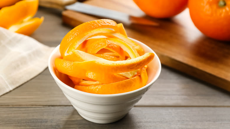 Fresh orange peels in bowl