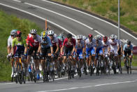 Athletes in the peloton climb during the men's cycling road race at the 2020 Summer Olympics, Saturday, July 24, 2021, in Oyama, Japan. (AP Photo/Christophe Ena)