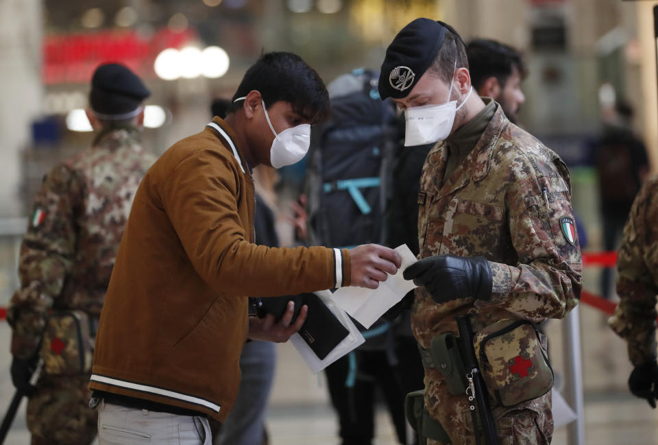 Police officers and soldiers check passengers leaving from Milan main train station, Italy, Monday, March 9, 2020. Italy took a page from China's playbook Sunday, attempting to lock down 16 million people — more than a quarter of its population — for nearly a month to halt the relentless march of the new coronavirus across Europe. Italian Premier Giuseppe Conte signed a quarantine decree early Sunday for the country's prosperous north. Areas under lockdown include Milan, Italy's financial hub and the main city in Lombardy, and Venice, the main city in the neighboring Veneto region. (AP Photo/Antonio Calanni)