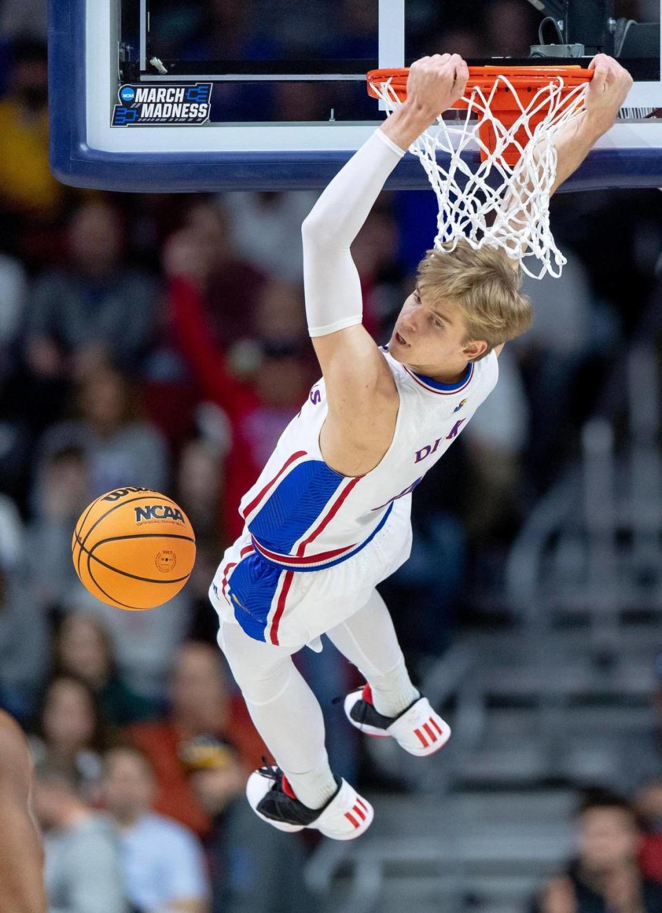 Kansas guard Gradey Dick (4) hangs on the rim after dunking against Arkansas during a second-round college basketball game in the NCAA Tournament Saturday, March 18, 2023, in Des Moines, Iowa.