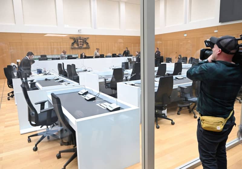 A cameraman films the start of the trial of a 29-year-old Eritrean man charged with a major breach of the peace, causing serious bodily harm, and allegedly assaulting police officers. Bernd Weißbrod/dpa