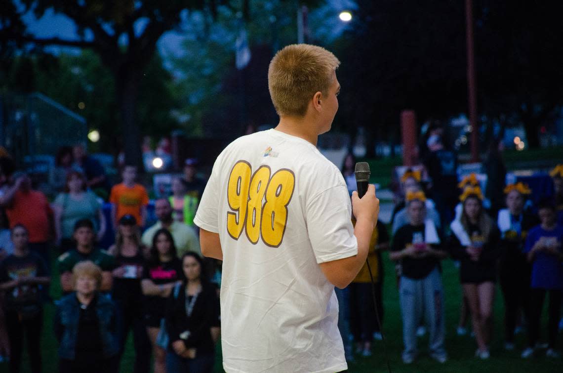 Sporting a T-shirt with the new Suicide & Crisis Lifeline 988 phone number, Richland High School junior Max Schuster speaks to hundreds of students and community members at the 7th annual Take Strides TC Suicide Prevention Walk in Richland, WA.