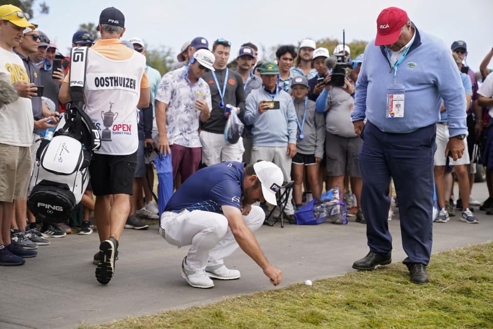 Louis Oosthuizen, of South Africa, gets a ruling from an official on his ball placement on the 14th fairway during the final round of the U.S. Open Golf Championship, Sunday, June 20, 2021, at Torrey Pines Golf Course in San Diego. (AP Photo/Jae C. Hong)