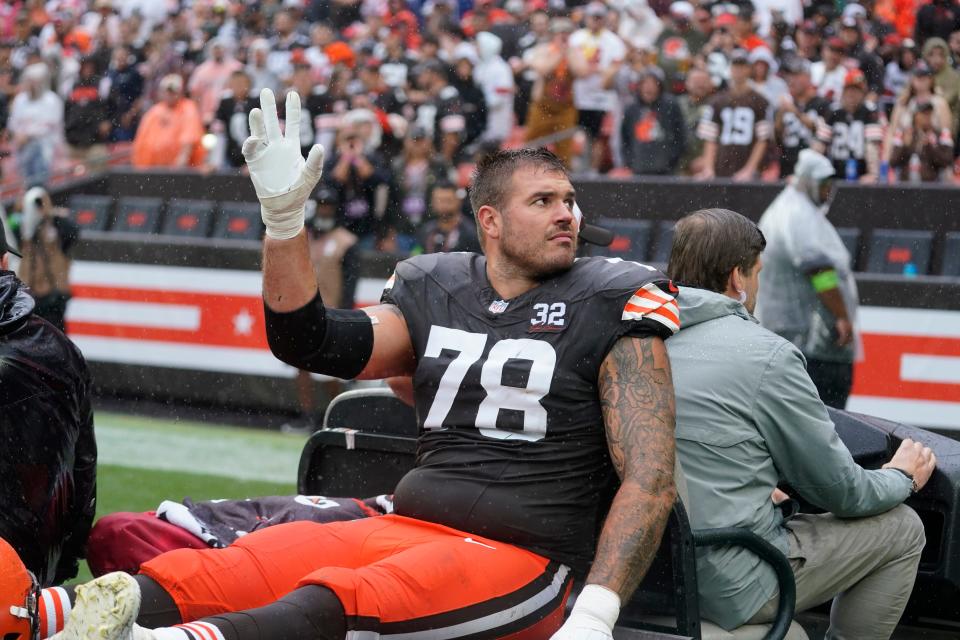 Cleveland Browns offensive tackle Jack Conklin (78) is takes off the field following an injury during the first half of an NFL football game against the Cincinnati Bengals Sunday, Sept. 10, 2023, in Cleveland. (AP Photo/Sue Ogrocki)