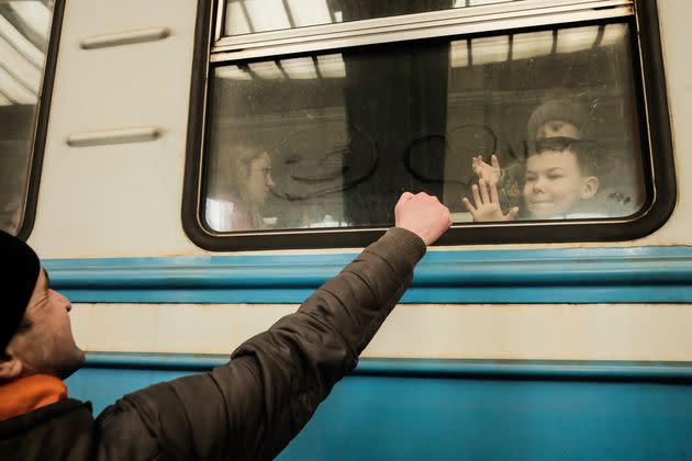 A Ukrainian refugee says goodbye to his family as the train prepares to depart. Since the beginning of the Russian invasion of Ukraine, around 2 million refugees have fled from their homes and crossed to Poland and other neighboring countries. (Photo: Matthew Hatcher/SOPA Images/LightRocket via Getty Images)