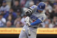 Los Angeles Dodgers designated hitter Shohei Ohtani hits a double during the first inning of a baseball game against the Minnesota Twins, Monday, April 8, 2024, in Minneapolis. (AP Photo/Abbie Parr)