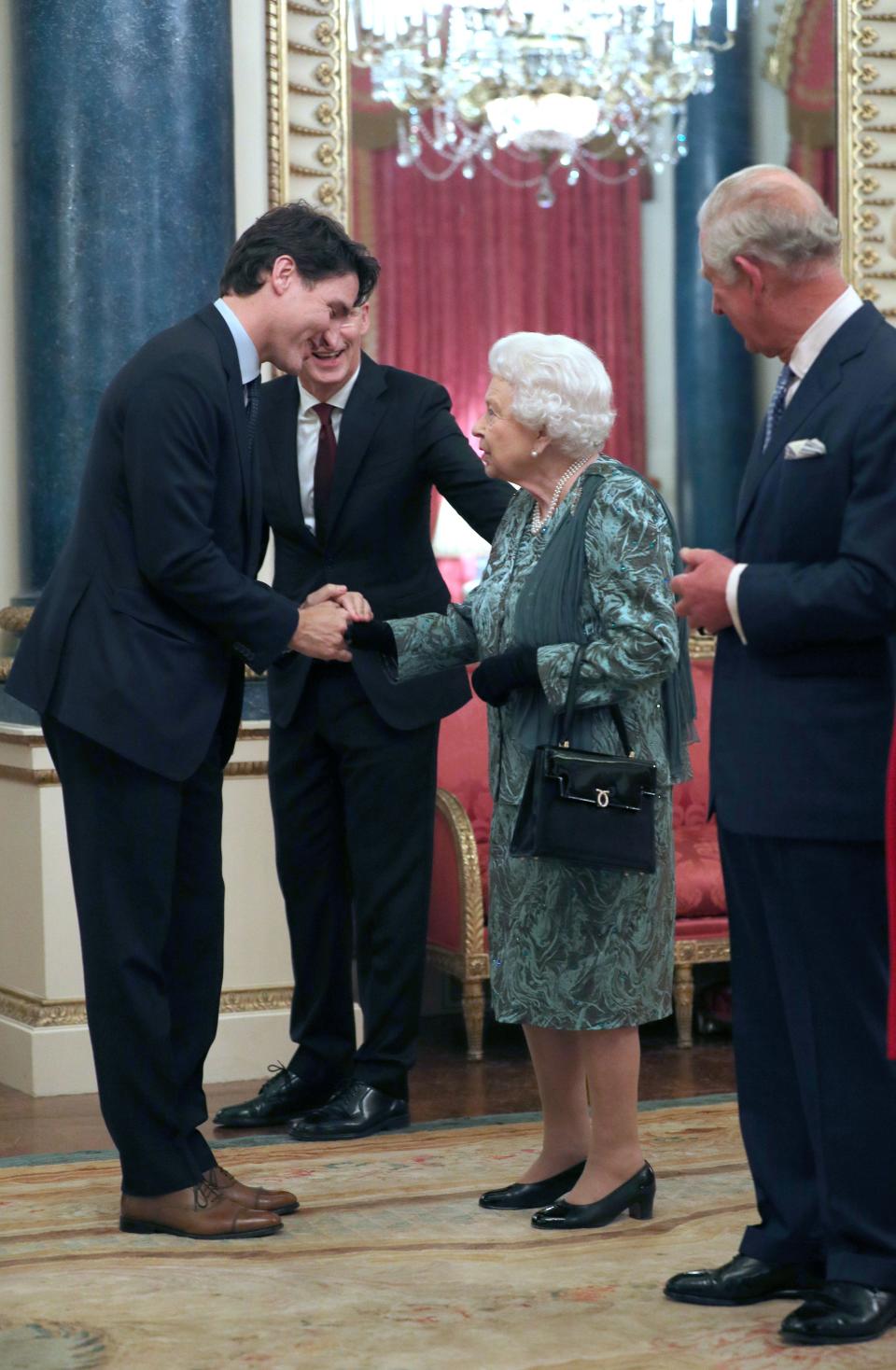 Britain's Prince Charles, Prince of Wales (R) looks on as Britain's Queen Elizabeth II meets Canada's Prime Minister Justin Trudeau (L) at Buckingham Palace in central London on December 3, 2019, during a reception hosted by Britain's Queen Elizabeth II ahead of the NATO alliance summit. - NATO leaders gather Tuesday for a summit to mark the alliance's 70th anniversary but with leaders feuding and name-calling over money and strategy, the mood is far from festive. (Photo by Yui Mok / POOL / AFP) (Photo by YUI MOK/POOL/AFP via Getty Images)