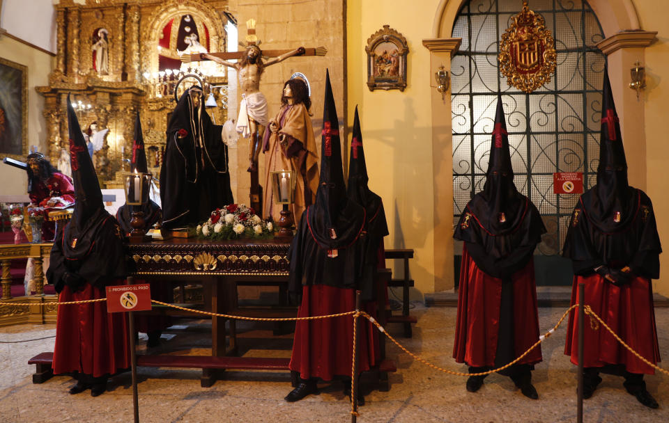 Members of the "Paso del Calvario" or Calvary Pass brotherhood keep vigil on Good Friday inside La Merced Catholic church in La Paz, Bolivia, Friday, April 2, 2021. Christians in Latin America mark Good Friday amid the coronavirus pandemic for the second consecutive year with some religious sites open to limited numbers of faithful but none of the mass pilgrimages usually seen in the Holy Week leading up to Easter. (AP Photo/Juan Karita)
