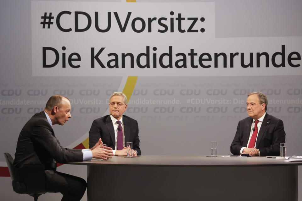 FILE - In this Dec. 14, 2020 file photo, the three candidates for the chairmanship of the Christian Democratic Union party, CDU, Friedrich Merz, left, Norbert Roettgen, center, and Armin Laschet, right, take part in a discussion at the party's headquarters in Berlin, Germany, Monday, Dec. 14, 2020. Background slogan reads: 'CDU Chairmanship: The candidate round'. The coronavirus pandemic is colliding with politics as Germany embarks on its vaccination drive and one of the most unpredictable election years in its post-World War II history.(AP Photo /Markus Schreiber, File)