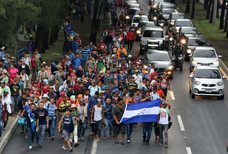 Honduran migrants heading in a caravan to the United States, walk in direction to Tecun Uman -- the border with Mexico -- as they leave Guatemala City, on October 18, 2018